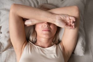 Woman experiencing menopause symptoms. Feeling sick.