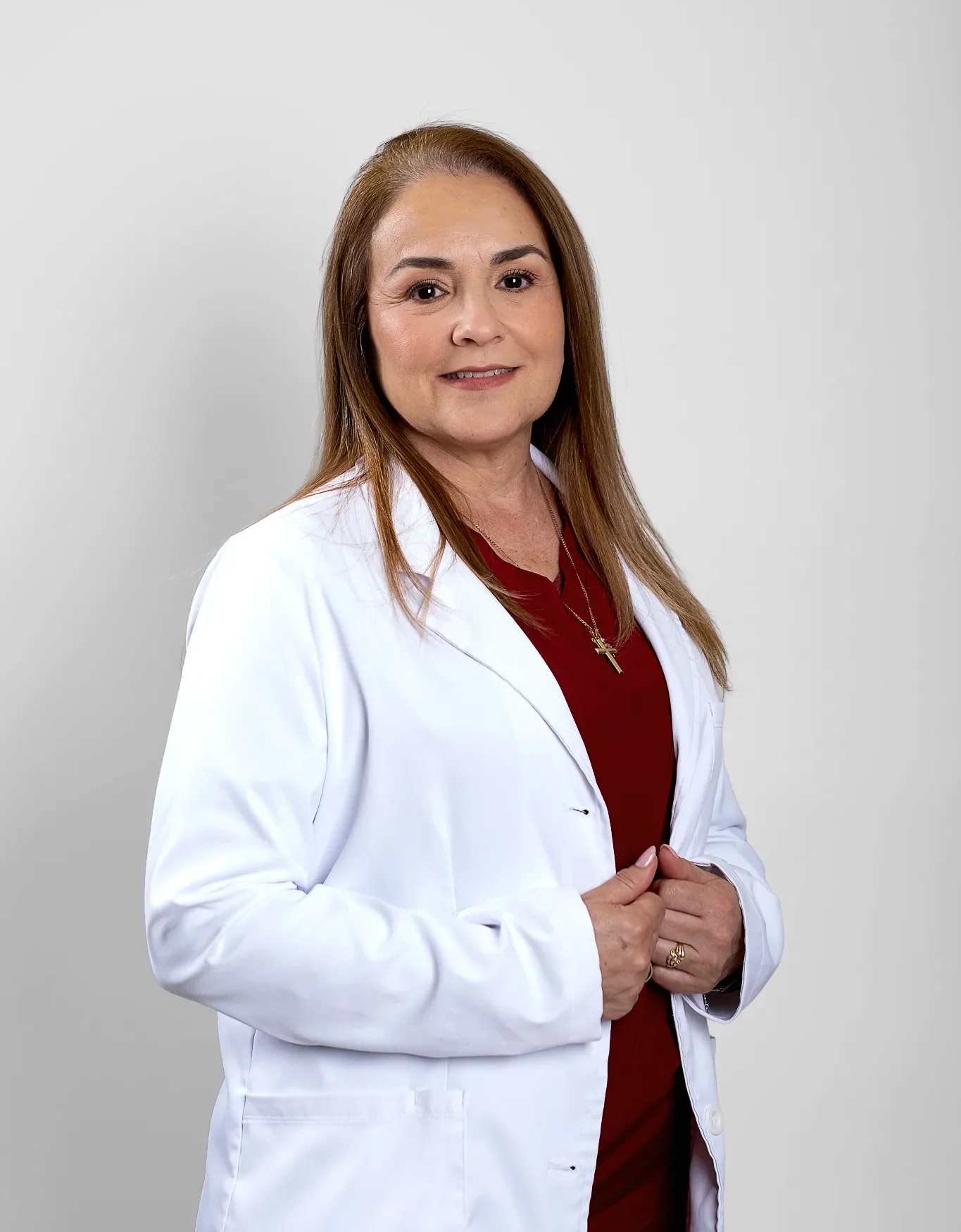 Middle-aged female doctor in white coat smiling confidently Female doctor in white coat smiling